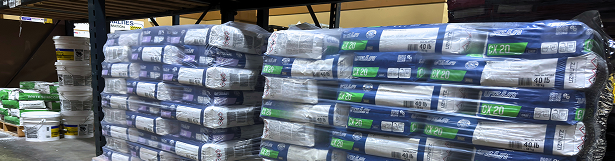 Pallets of rolled insulation stacked in a warehouse
