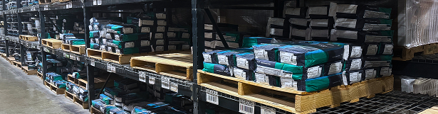 Shelves with stacked flooring materials in warehouse