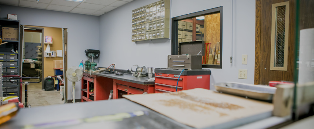 Workshop with red tool cabinets, workbenches, and storage bins