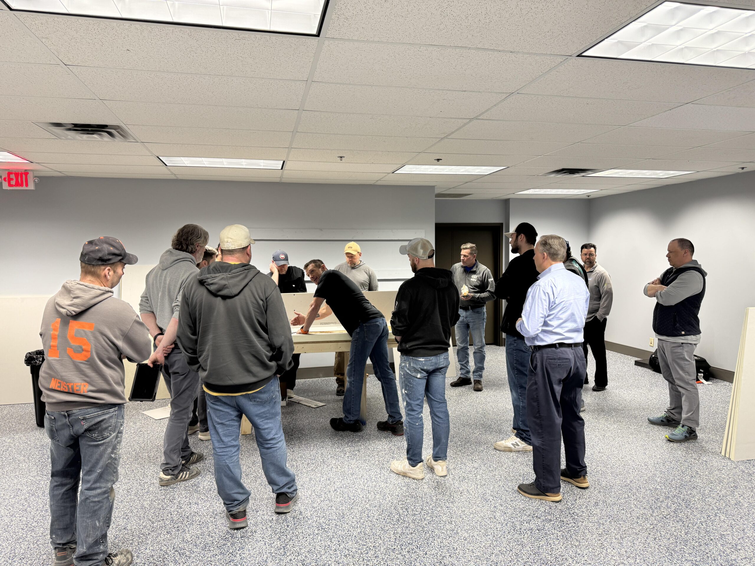 Group watching hands-on demonstration at center table